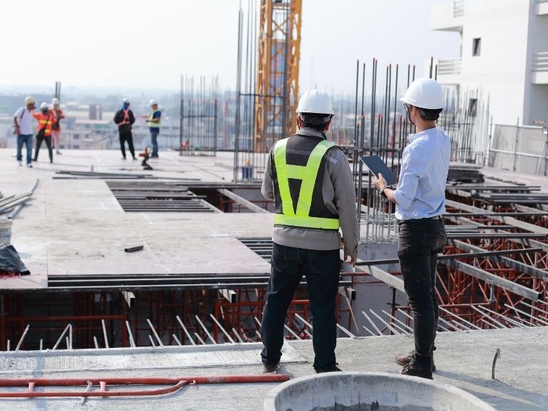 Civil engineer and project team reviewing site conditions before construction begins on a commercial development.