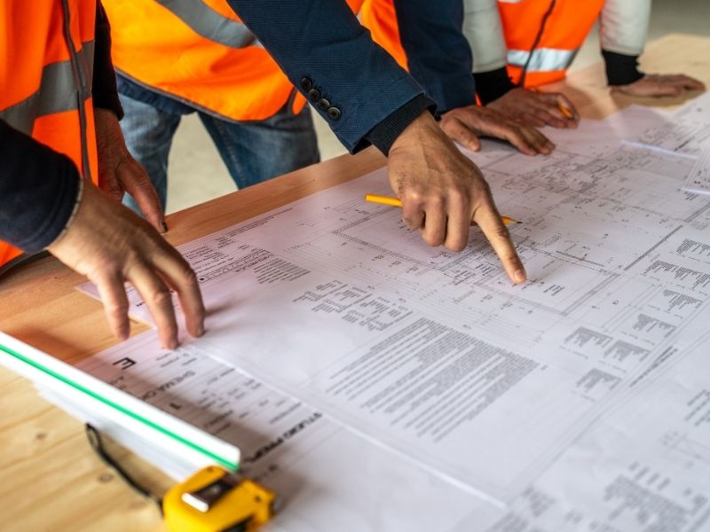 Civil engineering team reviewing a multifamily site plan and land entitlement requirements in Pensacola, FL.
